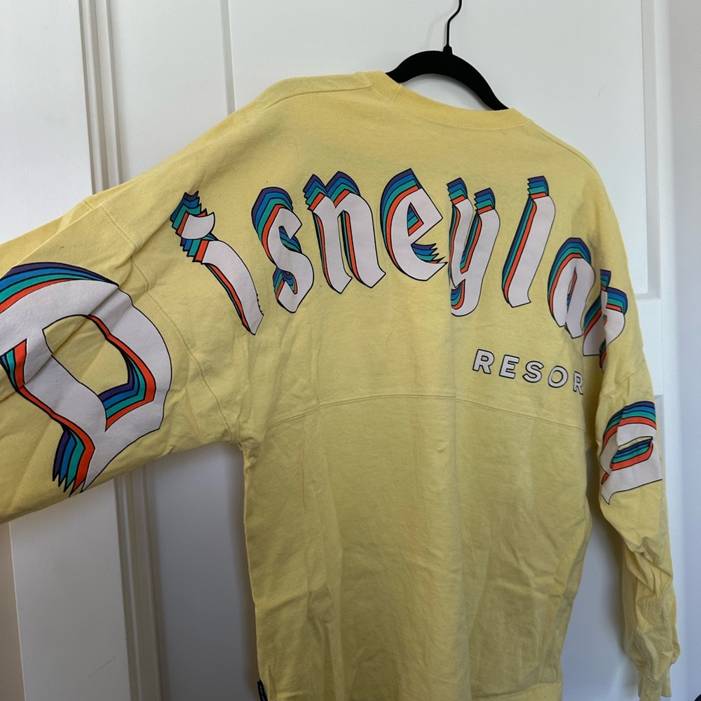 DISNEY PARKS DISNEYLAND YELLOW RETRO RAINBOW LOGO SPIRIT JERSEY